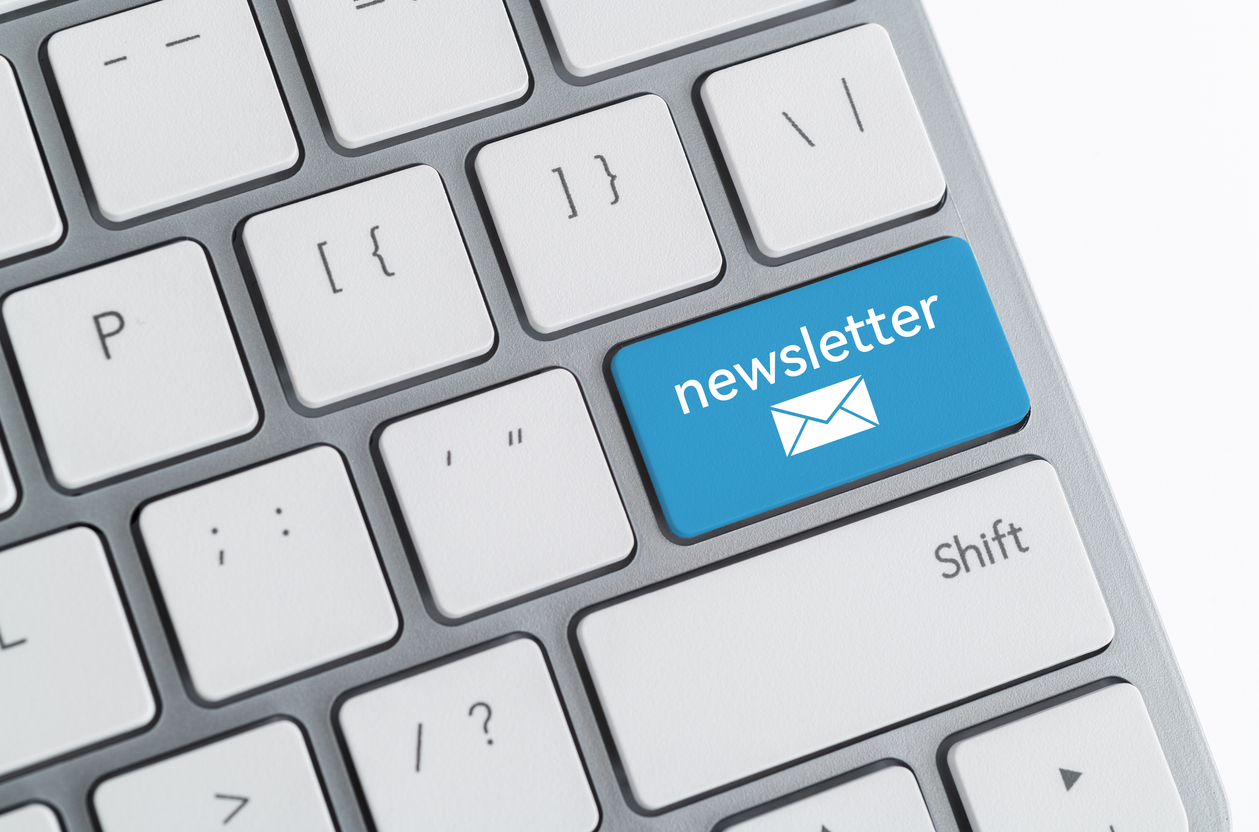 Computer keyboard with word newsletter and email icon